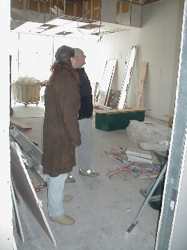 Ray shows Jill what is being done.